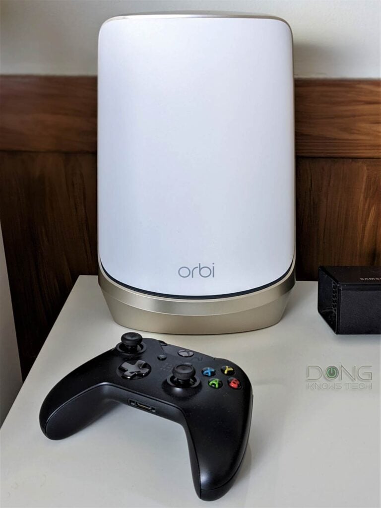 The Netgear Orbi RBSE960 Next To an XBOX Controller